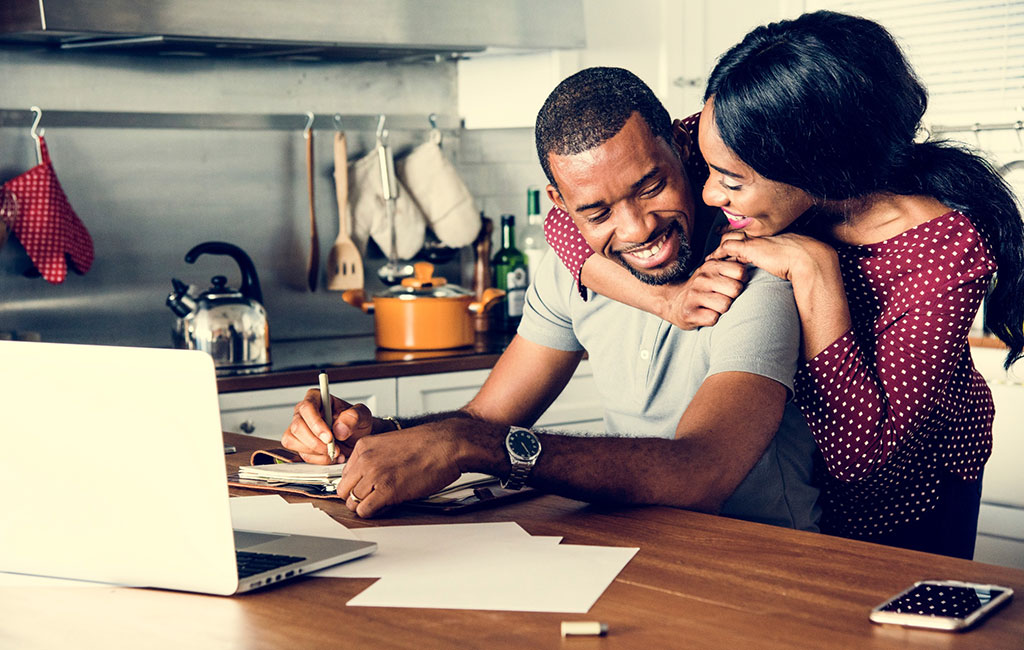 Couple Smiling Over Financial Documents